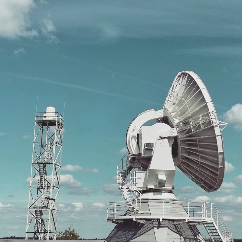 a large satellite dish sitting on top of a field